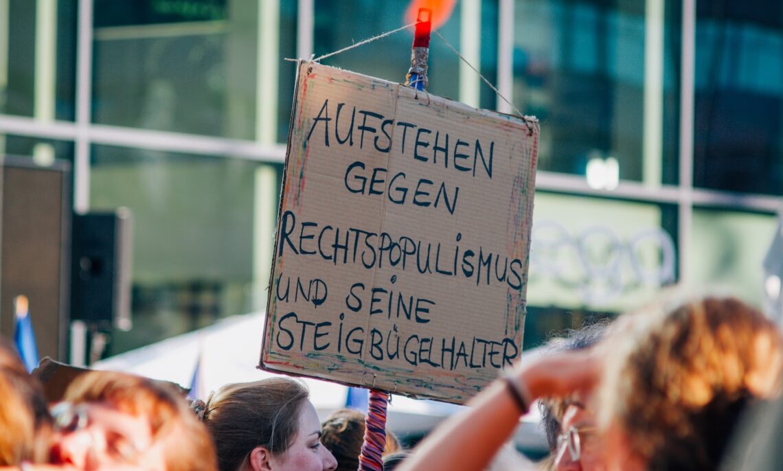 A group of people holding up signs in front of a building