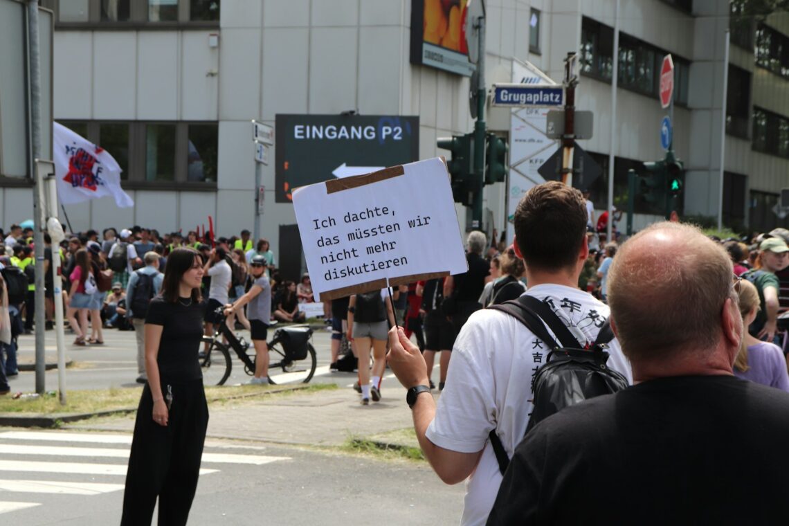 A group of people standing on the side of a road